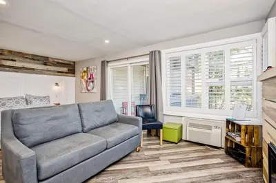a living room with a couch and a chair at Luxury Studio Getaway at Blue Mountains 80114 in Blue Mountains