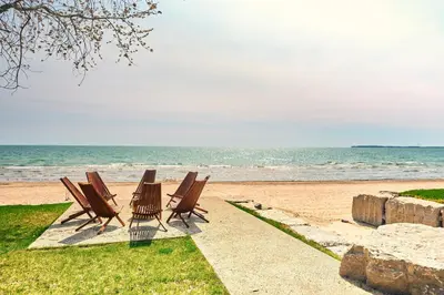 a group of chairs sitting on the beach at The Long Beach Resort - Beachfront Cottages & Townhouse Suites in Wainfleet
