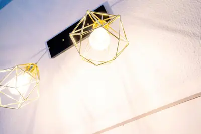 two lights are hanging on a wall at Loft with a view of Blue - Free Wifi, Linens and Towels Included in Blue Mountains