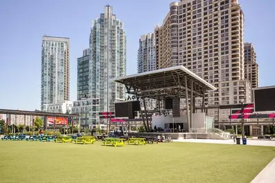 a park with yellow tables and chairs in a city at PlanURstay in Mississauga