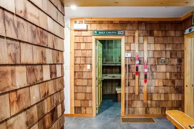 a building with a wooden wall with skis on it at Blue Mtn Chalet with a Sauna, Sleeps 20 in Blue Mountains