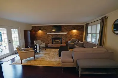 a living room with a couch and a fireplace at Arrowstone Farmhouse in Historic Old Town in Niagara on the Lake