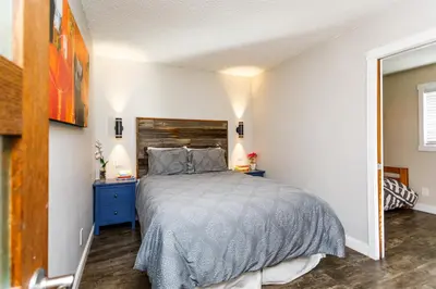 a bedroom with a bed and a blue dresser at Cozy Collingwood Retreat 80204 in Collingwood
