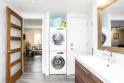 a bathroom with a washer and dryer in a room at Cozy Collingwood Retreat 80204 in Collingwood