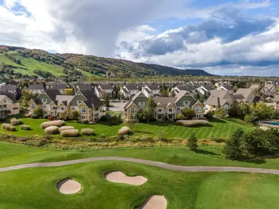 a view of a golf course with houses at 2 Bedroom Rivergrass with a View in Blue Mountains