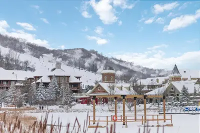 a lodge in the snow with a mountain in the background at 2 Bedroom Rivergrass with a View in Blue Mountains