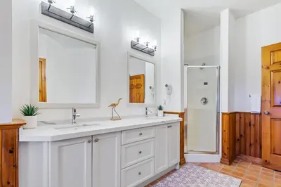 a white bathroom with two sinks and a shower at Blue Mountain 3 bedroom Dream Chalet 81590 in Collingwood