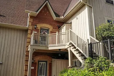 a dog is looking out of the window of a house at Blue Mountain 3 bedroom Dream Chalet 81590 in Collingwood