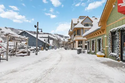 a snow covered street in a town with houses at Blue Mountain 3 bedroom Dream Chalet 81590 in Collingwood