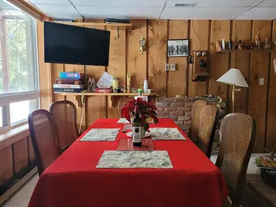 a dining room with a table with a red table cloth at Whispering Pines Suite at The Bowering Lodge in Blue Mountains