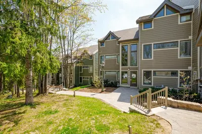 a house with a walkway in front of it at Ski In Out Mountainside Chalet 83001 in Blue Mountains