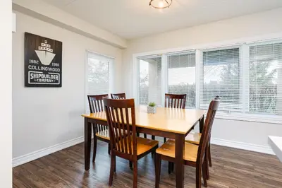 a dining room with a wooden table and chairs at Wintergreen Retreat with Private Sauna & Patio 82291 in Blue Mountains