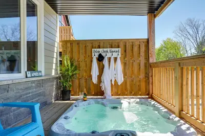 a hot tub on a deck with a fence at Luxury Mountain Retreat with private hot tub 82958 in Blue Mountains