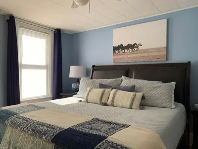 a bedroom with a bed with blue walls at THE YORK HOUSE BOUTIQUE Stay in Fort Erie