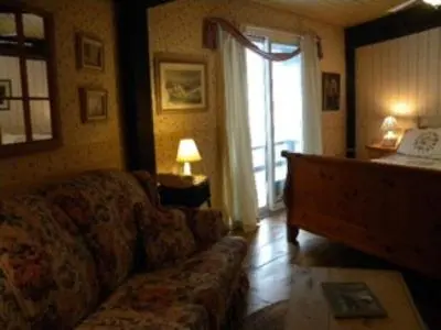 a living room with a couch and a window at Stouffermill Bed & Breakfast in Algonquin Highlands