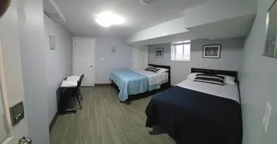 a bedroom with a bed and a table in it at Prestige Accommodation in Ajax