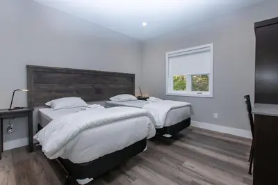 a bedroom with two beds and a window at 107 Birchview Trail in Blue Mountains