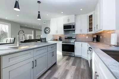 a large kitchen with white cabinets and a sink at 107 Birchview Trail in Blue Mountains