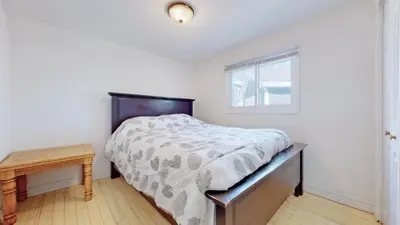 a bedroom with a large bed and a window at Main Beach River Retreat - Wasaga Beach 1 - Main Strip - 95 Mosley St in Wasaga Beach