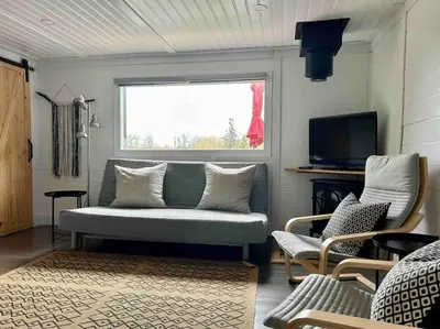 a living room with a couch and a window at The hidden nest in Marmora