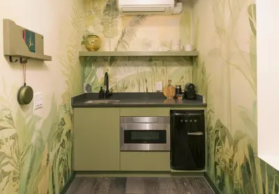 a kitchen with green plants on the wall at Ode in Toronto