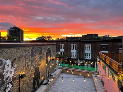 a rooftop view of a building with a sunset at Ode in Toronto