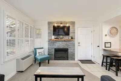 a living room with a fireplace and a tv at Blue Mountain Studio Oasis in Blue Mountains