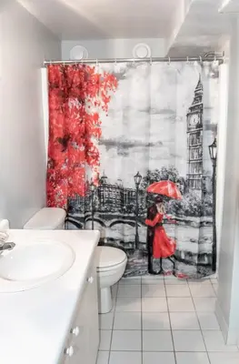 a bathroom with a shower curtain of a woman with an umbrella at The Jypsy Inn Notting Hill in Bracebridge