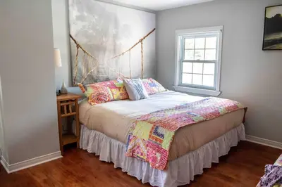 a bedroom with a bed and a window at The Jypsy Inn - Journey Apartment Muskoka in Bracebridge