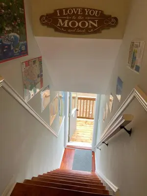 a staircase with a sign that says i love you to the moon at The Jypsy Inn - Journey Apartment Muskoka in Bracebridge