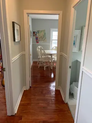 a hallway with a table and a dining room at The Jypsy Inn - Journey Apartment Muskoka in Bracebridge