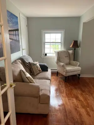 a living room with a couch and a chair at The Jypsy Inn - Journey Apartment Muskoka in Bracebridge