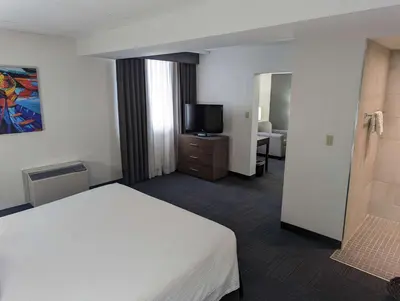 a hotel room with a bed and a flat screen tv at Best Western Plus Toronto Airport Hotel in Mississauga
