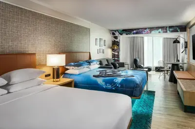 a hotel room with two beds and a living room at Sheraton Gateway Hotel in Toronto International Airport in Mississauga