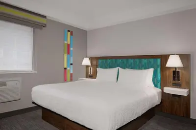 a bedroom with a large white bed and a window at Hampton Inn & Suites by Hilton Toronto Downtown in Toronto