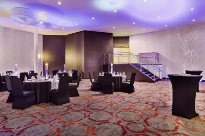 a banquet room with tables and chairs and a staircase at DoubleTree by Hilton Hotel Toronto Airport West in Mississauga