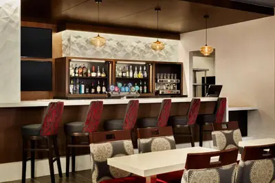 a bar in a restaurant with tables and chairs at DoubleTree by Hilton Hotel Toronto Airport West in Mississauga