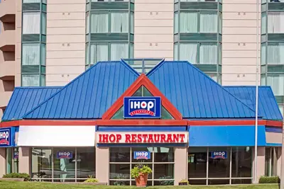 a mcdonalds restaurant with a blue roof at Ramada by Wyndham Niagara Falls/Fallsview in Niagara Falls