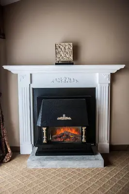a white fireplace with a box on top of it at Old Stone Inn Boutique Hotel in Niagara Falls