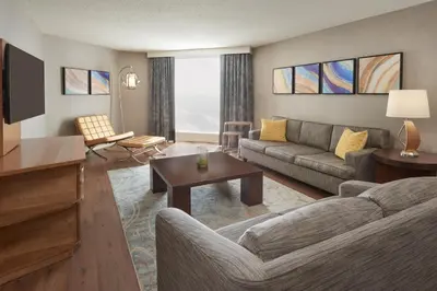 a living room with a couch and a tv at The Westin Toronto Airport in Toronto