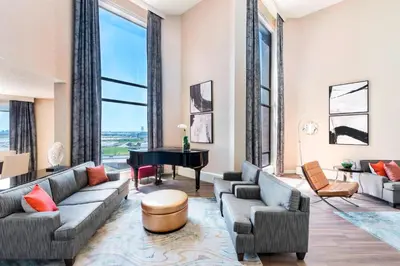 a living room with couches and a grand piano at The Westin Toronto Airport in Toronto