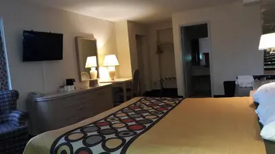 a hotel room with a large bed and a television at Super 8 by Wyndham Niagara Falls North in Niagara Falls