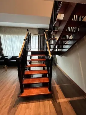 a spiral staircase in a living room with a couch at Cambridge Suites Toronto in Toronto
