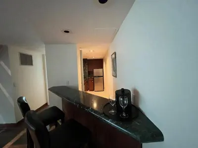 a kitchen with a counter with a coffee maker on it at Cambridge Suites Toronto in Toronto