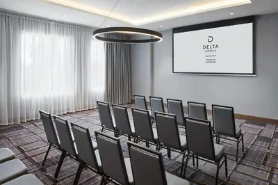 a conference room with chairs and a projection screen at Delta Hotels by Marriott Toronto Markham in Markham