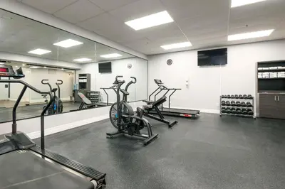 a gym with three exercise bikes in a room at Comfort Hotel in Niagara Falls