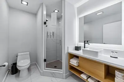 a bathroom with a toilet and a sink and a shower at Tower Hotel at Fallsview in Niagara Falls