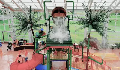 a water park with a water slide in a building at Americana Waterpark Resort & Spa in Niagara Falls