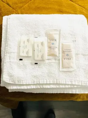 a table with three candles on a white towel at A1 Inn Niagara Falls in Niagara Falls