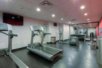 a gym with treadmills and machines in a room at Niagara Fallsview Hotel in Niagara Falls